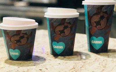 three BioPak disposable coffee cups with lids in different sizes